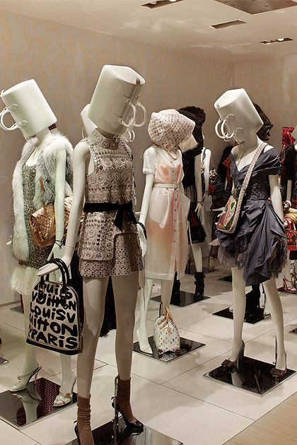 Beautiful Mannequins In Fashionable Clothes In Louis Vuitton Store