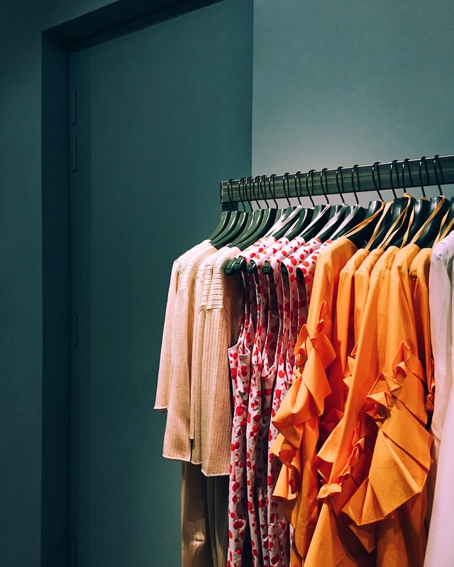 Clothes hanging on hangers in women clothing store